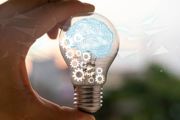 istock Light bulb with brain inside the hands of the businessman. 1395657863