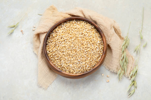 istock Dry oatmeal in bowl on light background. 1395657896