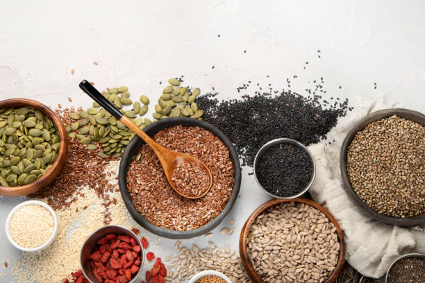 istock Variety of edible seeds on light background. 1395658912