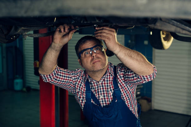 istock Auto mechanic working in garage. Repair service. 1395660523