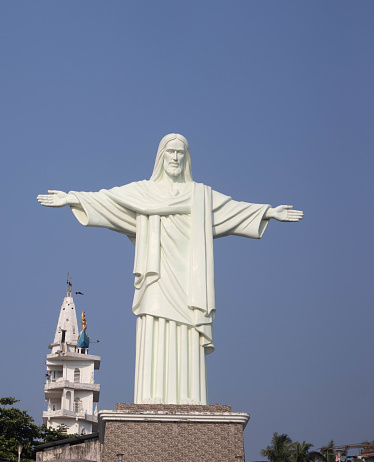 White color Christ statue with blue sky