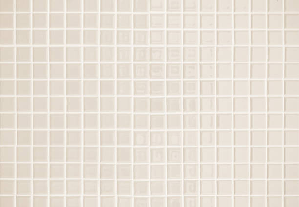 istock Beige ceramic wall and floor tile abstract background. Design geometric gray mosaic texture decoration of the bedroom. Simple seamless pattern grid for backdrop hospital wall, canteen and kitchen. 1395660705