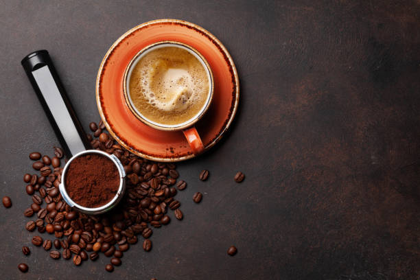 istock Roasted coffee beans and ground coffee in filter holder 1395663591