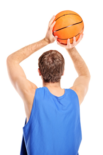 Basketball player aiming to shoot a ball isolated on white background