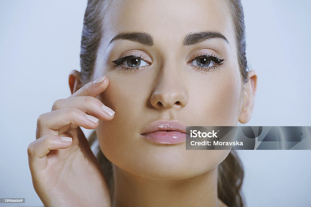 pretty girl touches the skin around eye pretty healthy girl touches the skin around the eye Adult Stock Photo