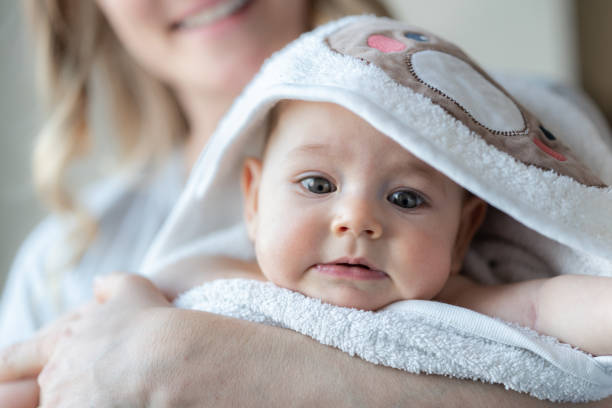 istock Mother carrying her baby after bath 1395666421