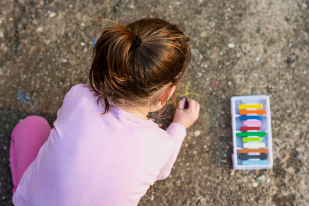 istock Child drawing whit chalk in the yard 1395667430