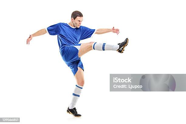 Soccer Player Shooting Foto de stock y más banco de imágenes de Azul - Azul, Camisa, Camiseta