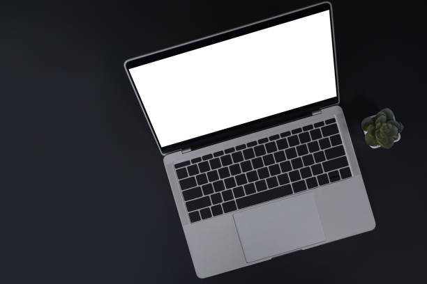 istock Top view mock up laptop computer with blank screen on black background. 1395669162