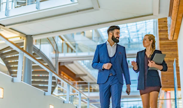 istock Business people walking in the hall 1395669716
