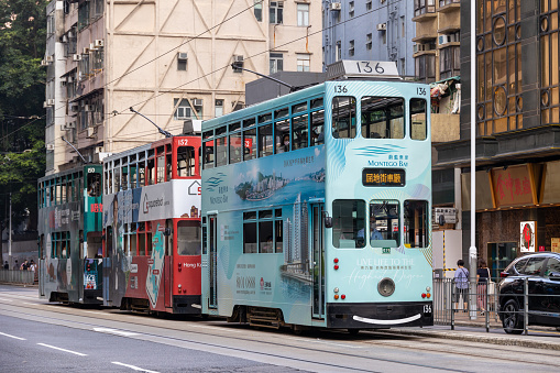 Hong Kong - April 14, 2022 : Double-decker trams in Sai Ying Pun, Hong Kong. Hong Kong has the world's largest operating fleet of double-decker trams.
