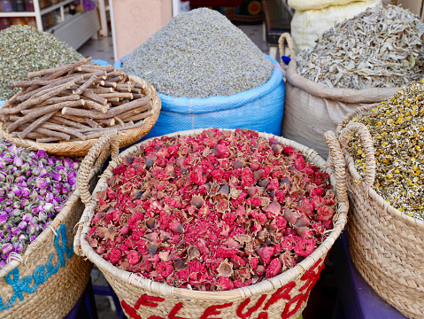 Colorful rosebuds, herbs and dried tea in the souk of Marrakech, Morocco. Close up.