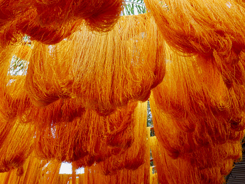 Bundles of dyed wool hanging to dry at dyers souk, Marrakech, Morocco.