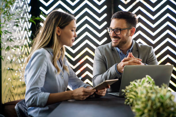 istock Business people having fun and chatting at workplace office 1395680745
