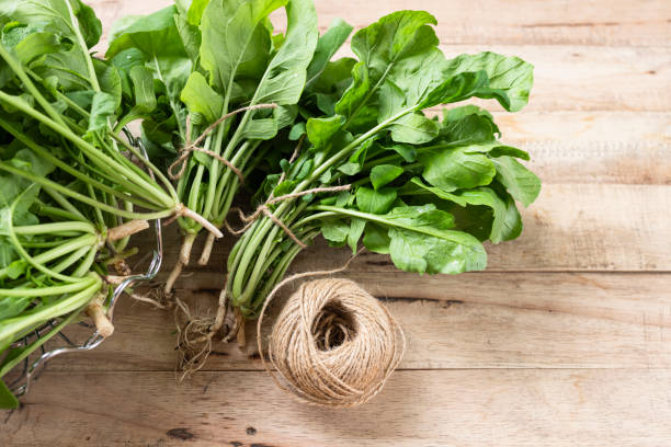 istock Fresh Arugula leaf on wood background. 1395680839
