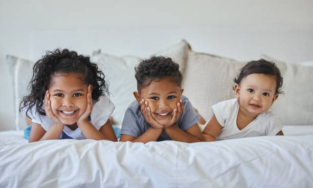 istock Shot of three siblings lying together in bed 1395681829