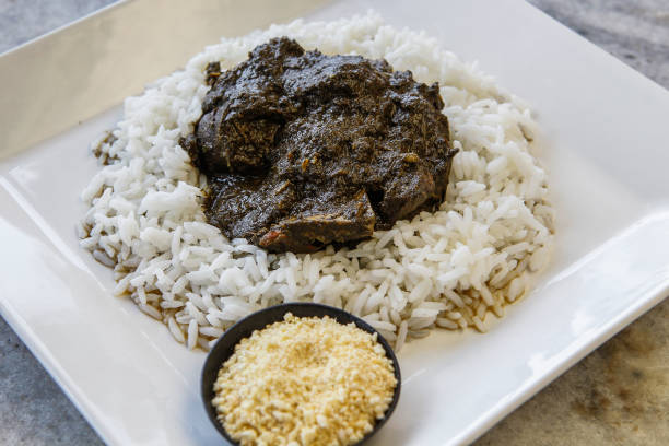 Traditional North Brazilian dish of Maniçoba Traditional North Brazilian dish of manicoba with rice, made slowly cooked cassava leaves and meats. Amazon Gastronomy. Comida Paraense. cirio de nazare stock pictures, royalty-free photos & images