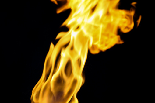 Shape of a fire burning. Yelow and orange flame on black background.