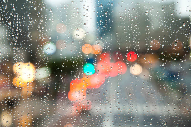 istock Defocused city view through rainy window, melancholic mood 1395683591