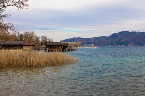 Attersee in the Salzkammergut in Austria. Beautiful natural beach with reeds and stilt huts. Upper Austria, Europe.