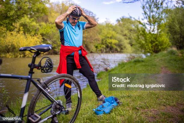 Active Senior Man Adjusting Hic Cycling Helmet Stock Photo - Download Image Now - 65-69 Years, Active Lifestyle, Active Seniors
