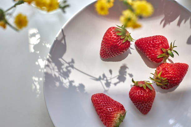 fresh strawberries in white plate, directly above