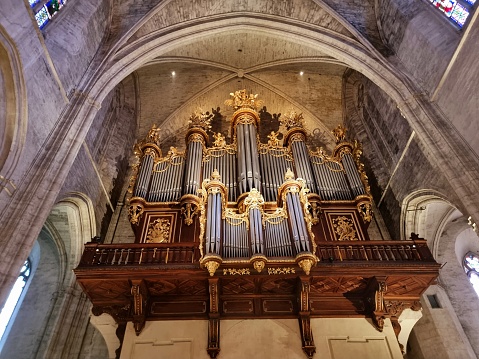 Close up view of a organist playing a church pipe organ with motion blur.