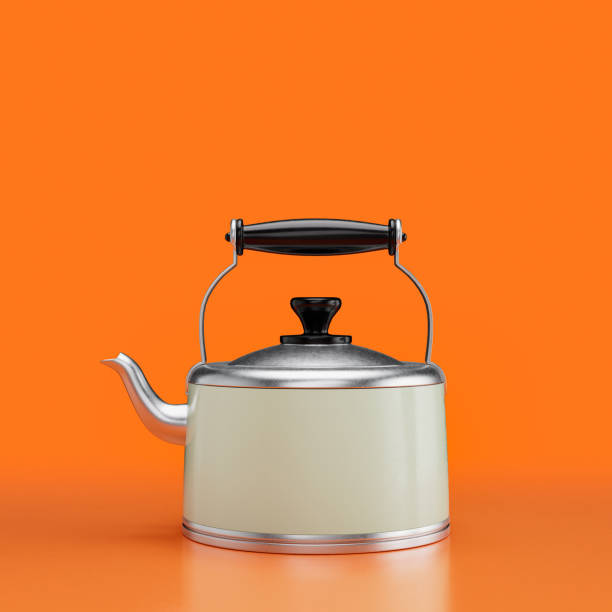 Cast iron tea pot on a stove and a white cup. Black and white photograph.