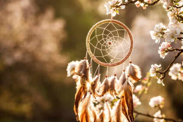 istock Dreamcatcher hanging on blooming tree in wind 1395692336