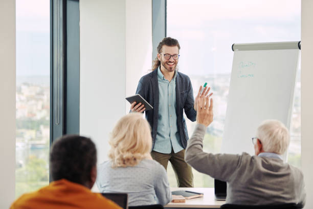 istock Young educator teaching a multicultural group of senior students in the classroom. 1395693353