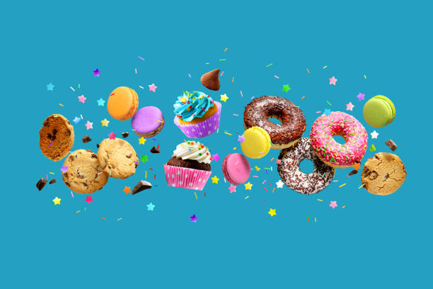istock Donuts, cupcakes, cookies, macarons flying over blue background. 1395693435