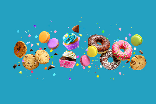 Cakes, sweets, confectionery collage background. Donuts, cookies cupcakes macaroons levitation over blue background