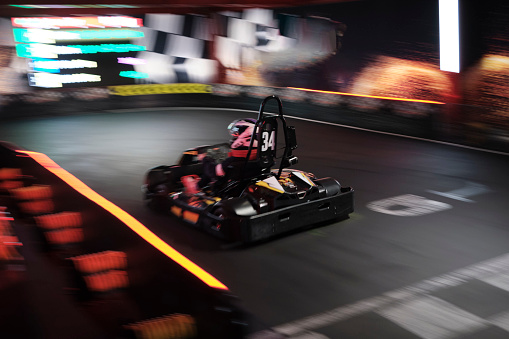 Competitive friends racing in go-carts - amusement park ride concepts