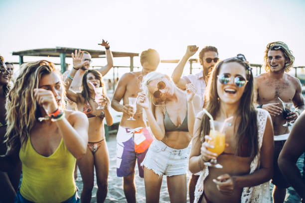 istock Young cheerful people having fun on a beach party. 1395693587