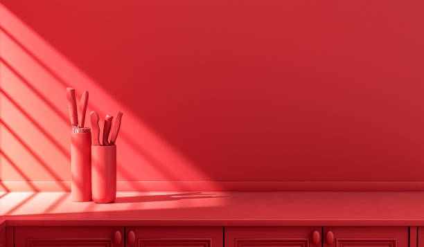 istock Stylized single color red kitchen counter and everyday utensils in morning sunlight. 1395694000