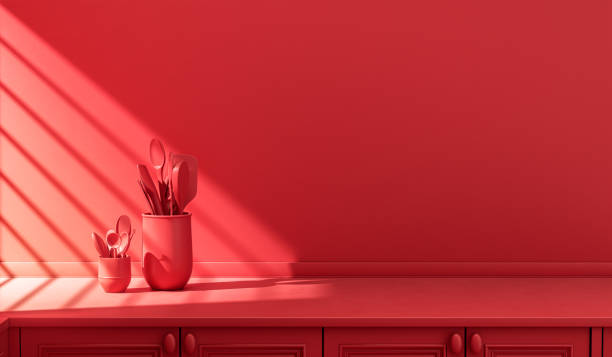 istock Stylized single color red kitchen counter and everyday utensils in morning sunlight. 1395694092