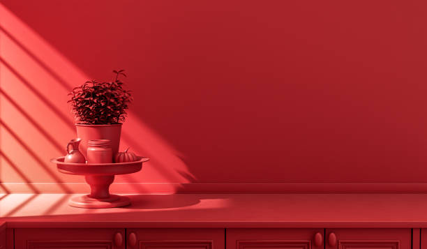 comptoir de cuisine rouge monochrome stylisé et ustensiles de tous les jours à la lumière du soleil du matin. - image monochrome photos et images de collection