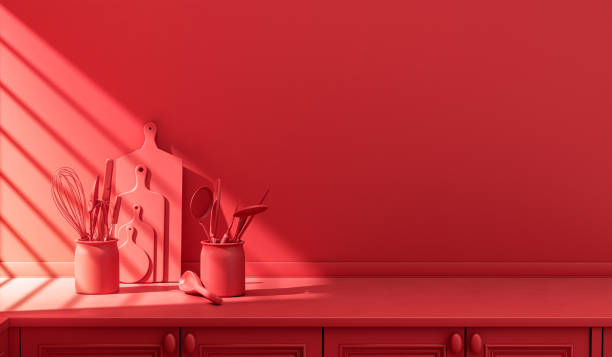 istock Stylized single color red kitchen counter and everyday utensils in morning sunlight. 1395694898