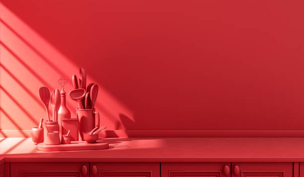 istock Stylized single color red kitchen counter and everyday utensils in morning sunlight. 1395694930