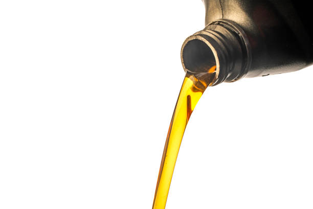istock Car lubricant flows from gray bottle on isolated white background. 1395696238
