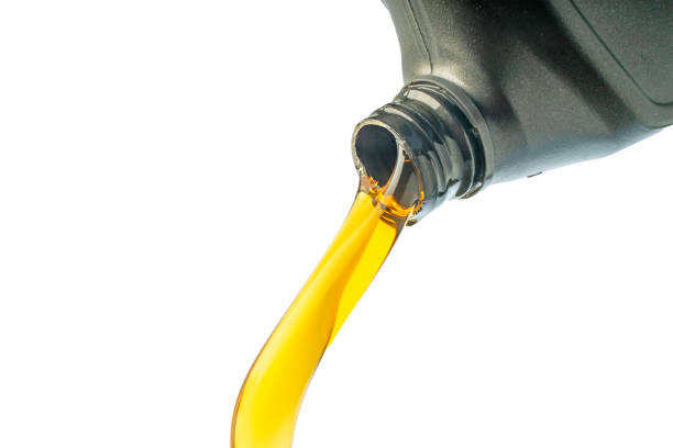 istock Car lubricant flows from gray bottle on isolated white background. 1395696251
