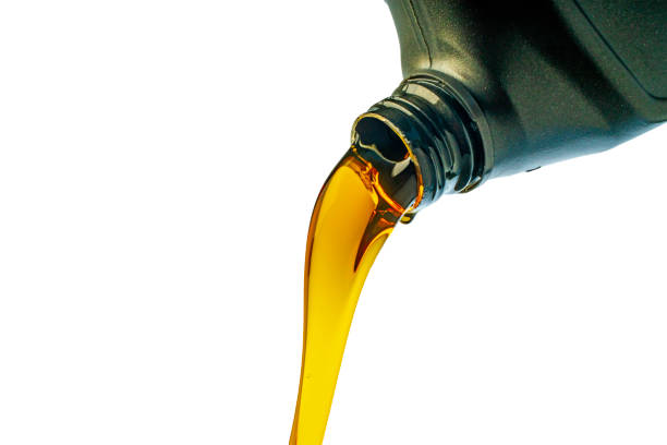 istock Car lubricant flows from gray bottle on isolated white background. 1395696252