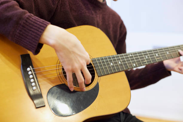 istock Japanese man playing the guitar 1395696398