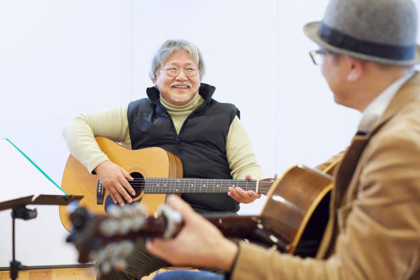 Japanese man playing the guitar
