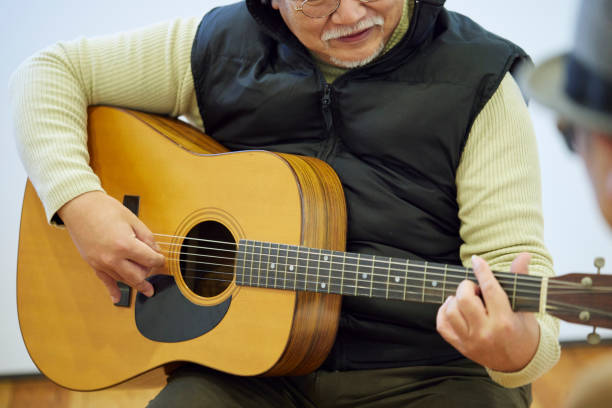 istock Japanese man playing the guitar 1395696400
