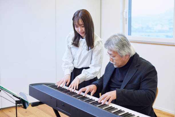 istock A young woman teaching the piano and a man teaching 1395696427