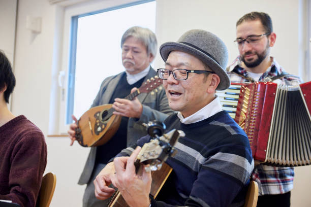 istock Adults playing musical instruments happily 1395696448