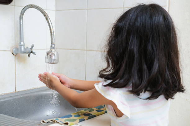 istock Back view of little kid washing her hand 1395698846
