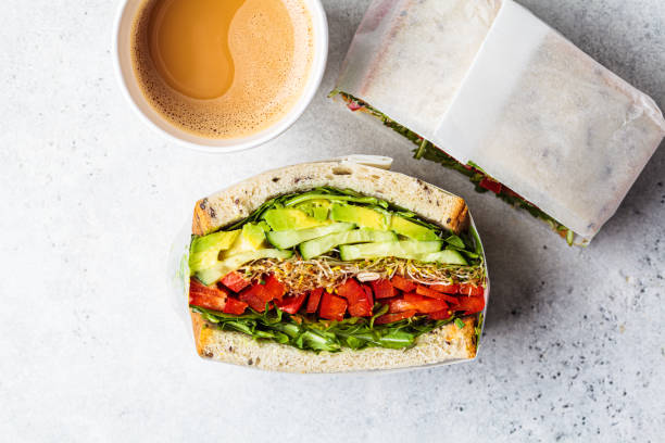 Vegetable sandwich in paper wrap. Vegan healthy food, takeaway food. stock photo