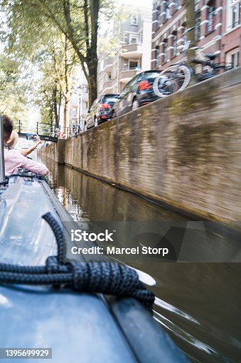 istock Boat passing through small canal 1395699929